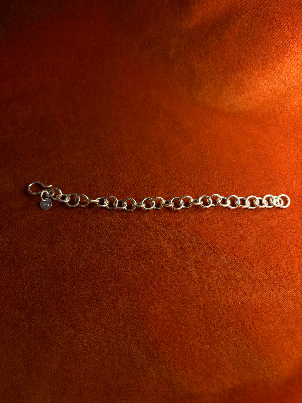 Sterling silver chunky chain displayed on an orange velvet backdrop.