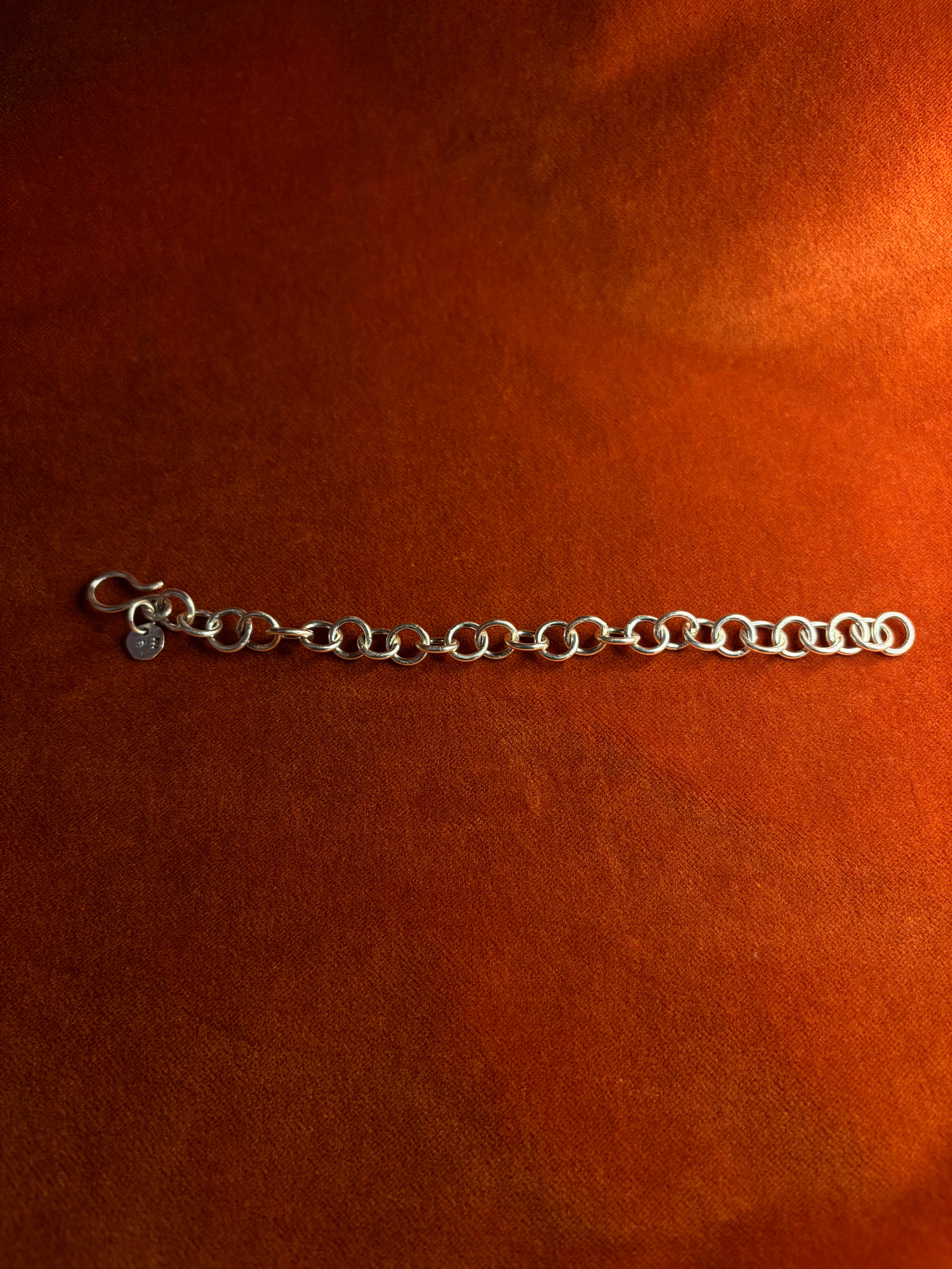 Sterling silver chunky chain displayed on an orange velvet backdrop.