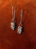 A pair of silver earrings with clusters of bubbles with an elongated clasp hook for a dangling style.